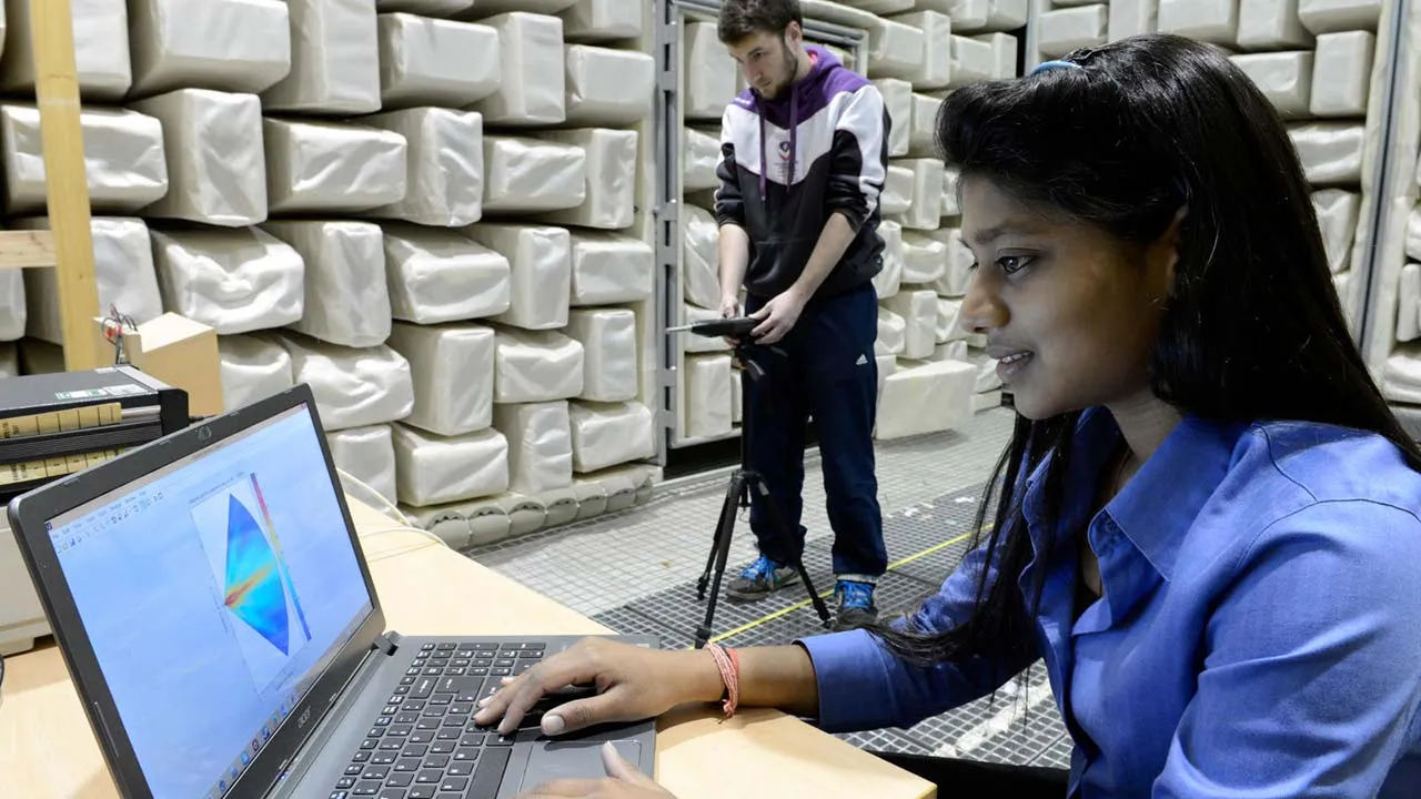 Two students carrying out research in the anechoic chamber