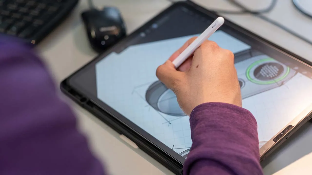 A person drawing with an apple pencil on an iPad