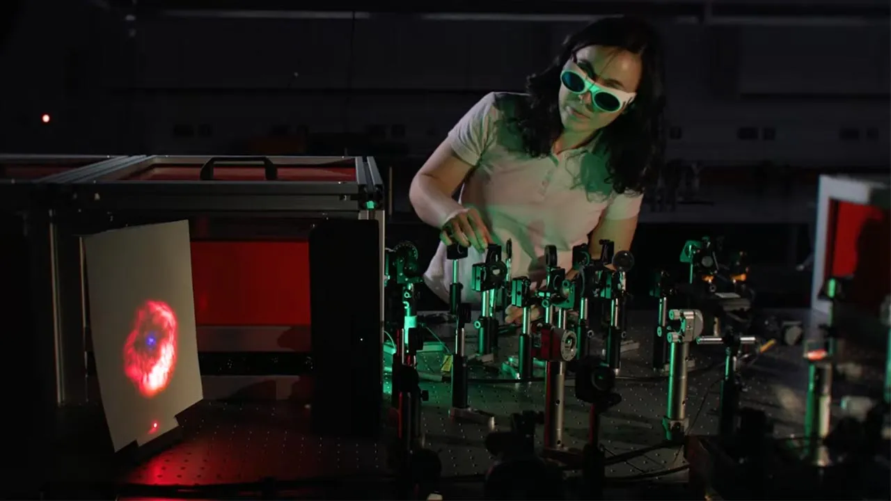 A physics student carrying out an experiment in a lab using technical equipment