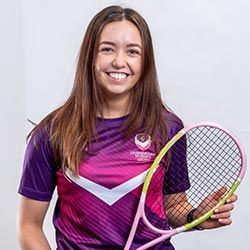 Piper Tatum wearing Loughborough Sport kit holding a squash racket