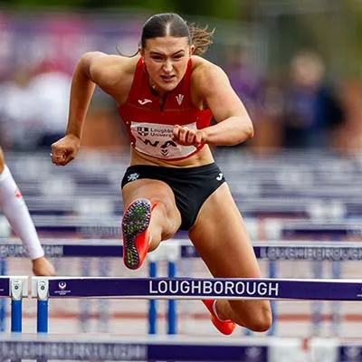 Abi Pawlett jumping over a hurdle