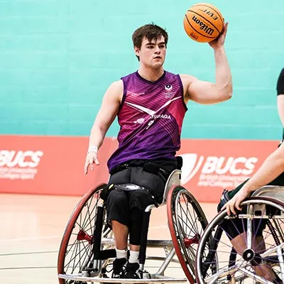 Alex Marshall-Wilson holding a basketball during a wheelchair basketball match