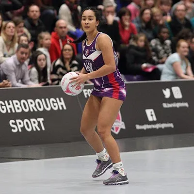 Brie Grierson holding a netball on the court during a match