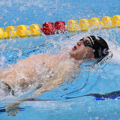 Conor Ferguson swimming backstroke