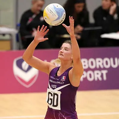 Fran Williams on a netball court catching the ball