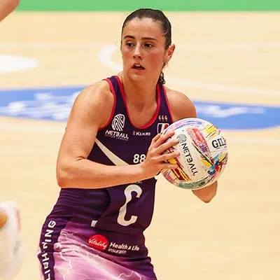 Jess Shaw holding a netball on the court