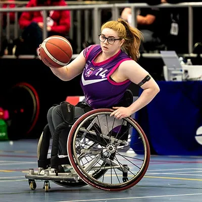 Kayli English with the ball during a wheelchair basketball match