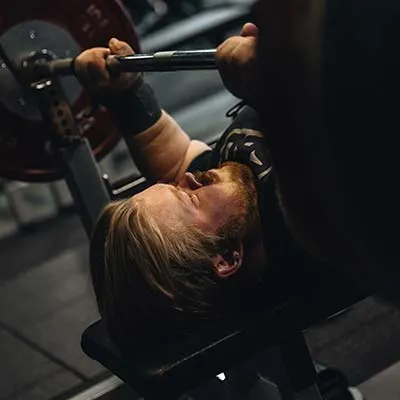 Mark Swan laying on a bench lifting weights