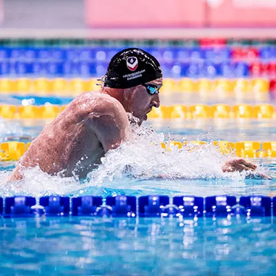 Max Litchfield swimming in a pool