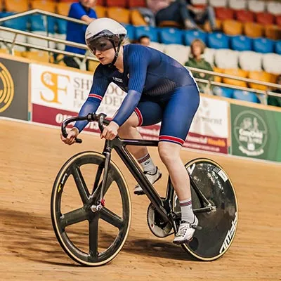 Rhian Edmunds cycling on an indoor track