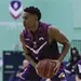 Reiss Pinnock on a basketball court holding the ball