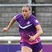 Mikayla Wildgoose in purple kit running on the football pitch