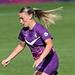 Monique Robinson in purple kit on the football pitch