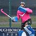 James Mazarelo in goal wearing a pink and black kit and blue padding.
