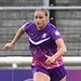 Mikayla Wildgoose in purple kit running on the football pitch