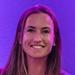 Maddie Hinch stood in front of a purple background and smiling at the camera