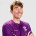 A photo of tennis coach Mike Shaw wearing a purple Loughborough Sport t-shirt