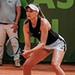 Olivia Nicholls on a tennis court holding a racket