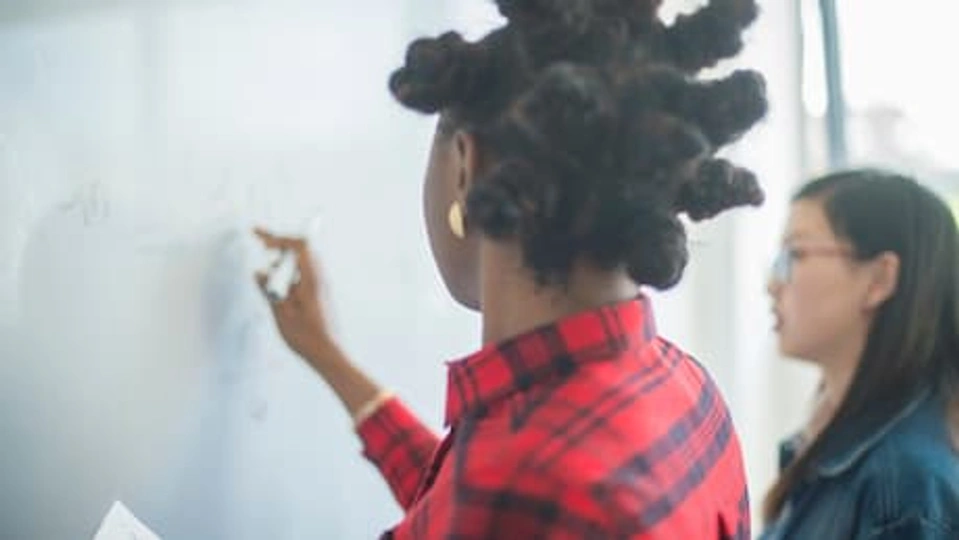 Student writing on whiteboard