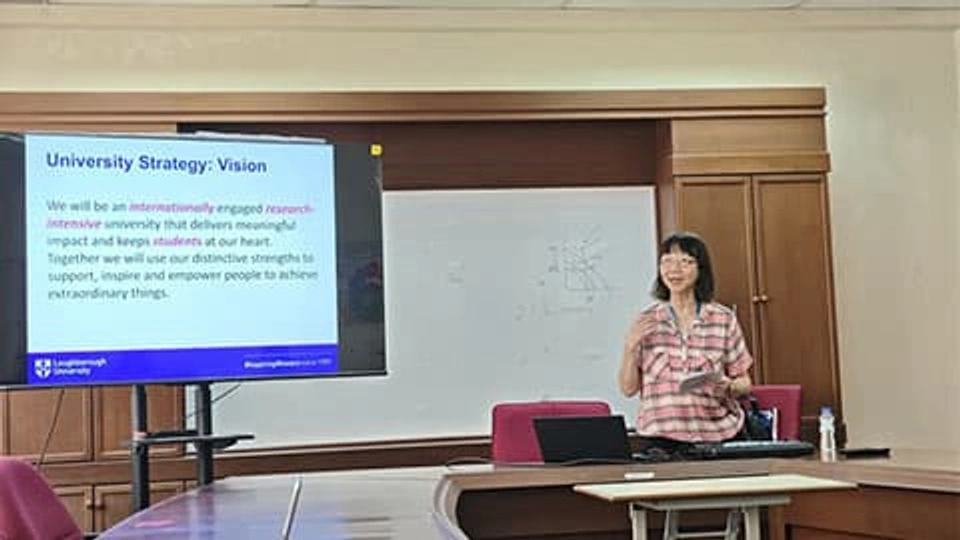Professor Dr Phebe Mann the standing up in a lecture room in Malaysia. She has a presentation up on the board which reads University Strategy: Vision. We will be an internationally engaged research-intensive university that delivers meaningful impact and keeps students at our heart. The University logo is at the bottom on the presentation.
