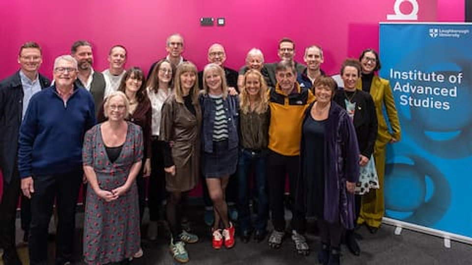 A group of people smiling, standing