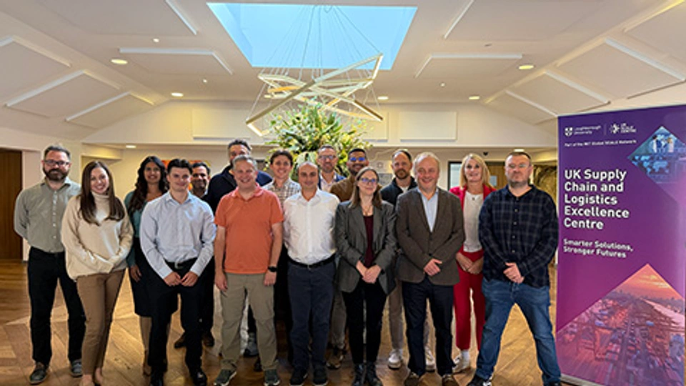 Delegates and facilitators at the UK SCALE Centre Supply Chain Strategy and Leadership Retreat gather beside a UK SCALE Centre banner.