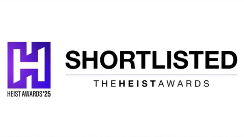 Logo and text for the Heist Awards 2025. A stylized purple and white 'H' logo appears on the left, with bold black text reading 'SHORTLISTED' to the right, and smaller text below stating 'THE HEIST AWARDS'
