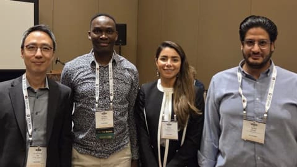 Dr Mumin Abubakre stands in a group with colleagues at ICIS 2025.