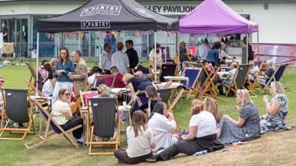 Loughborough Business School staff sat outside under gazebos at the Staff Celebration 2026.