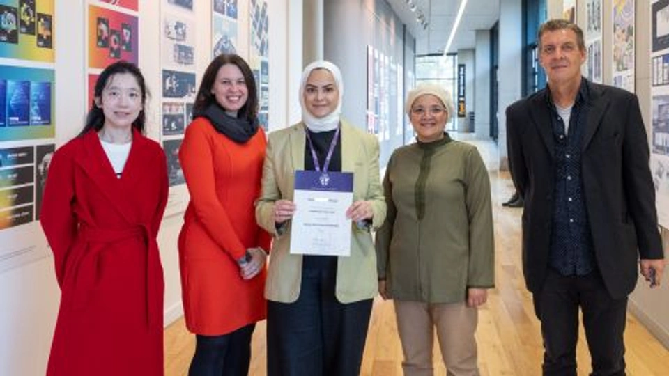 Dua's - Dennis Holt Travel Prize Winner stood with supporting staff