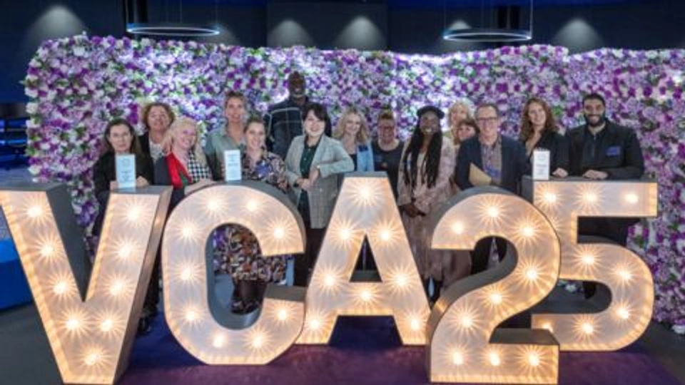SDCA Colleagues stood in front of VCA lights with their awards