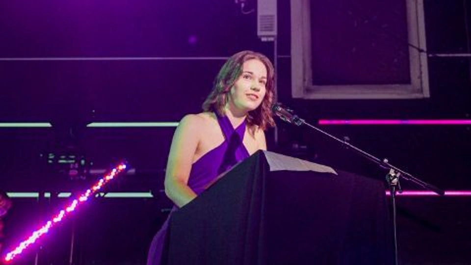 Daisy Newton, Industrial Design student, speaking through a microphone