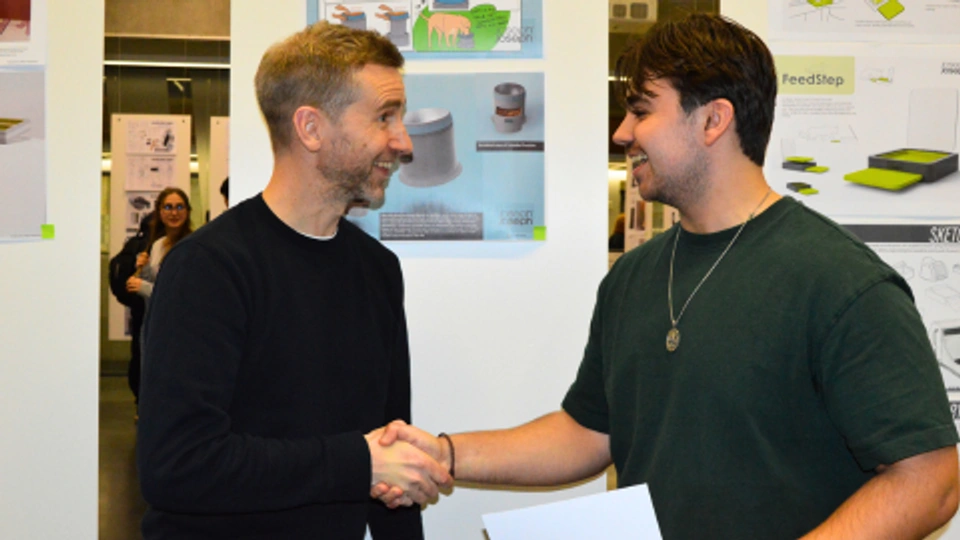 Gareth from Joseph Joseph shaking hands with winning student