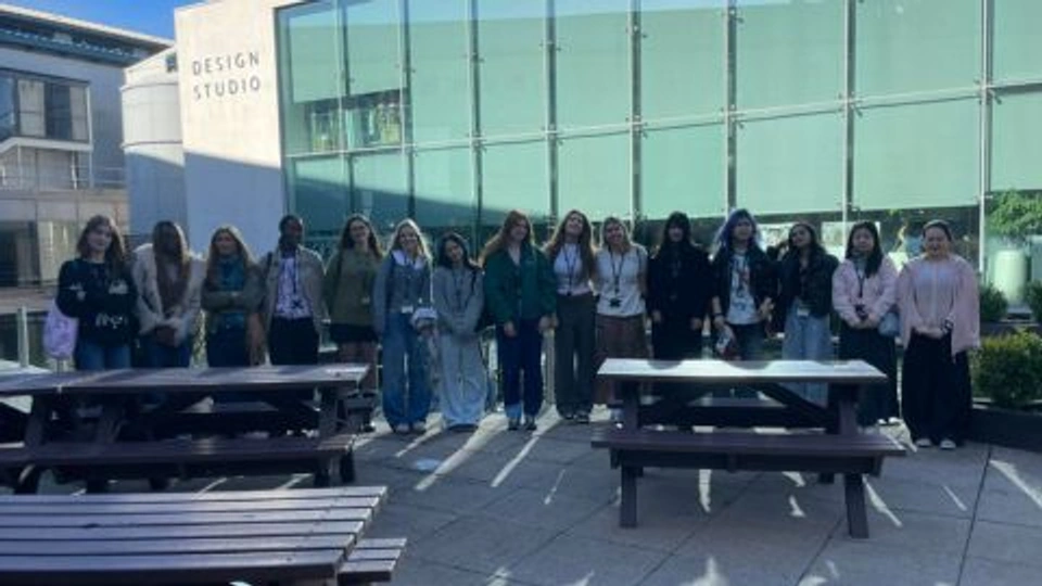 Fashion Design students in a group photo in front of NEXT design studios