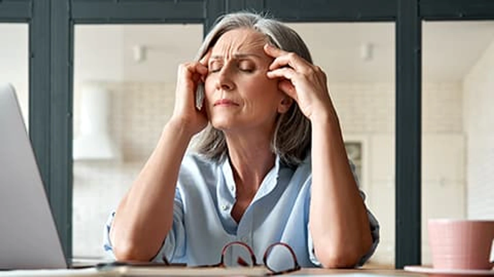 A woman holding her head