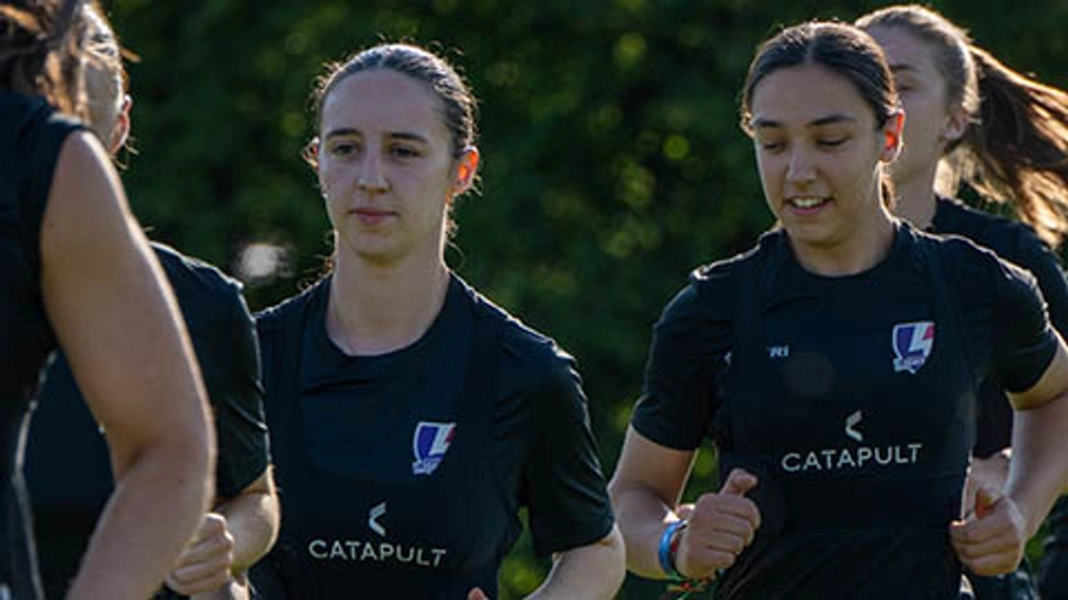 Two of our Lightning football players are running in training.