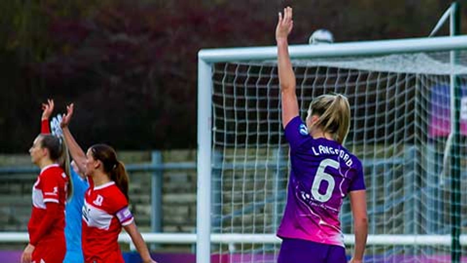 A Lightning football player standing on the pitch with back to the camera