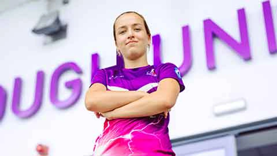 A Loughborough Lightning football player stood, looking into the camera with their arms folded