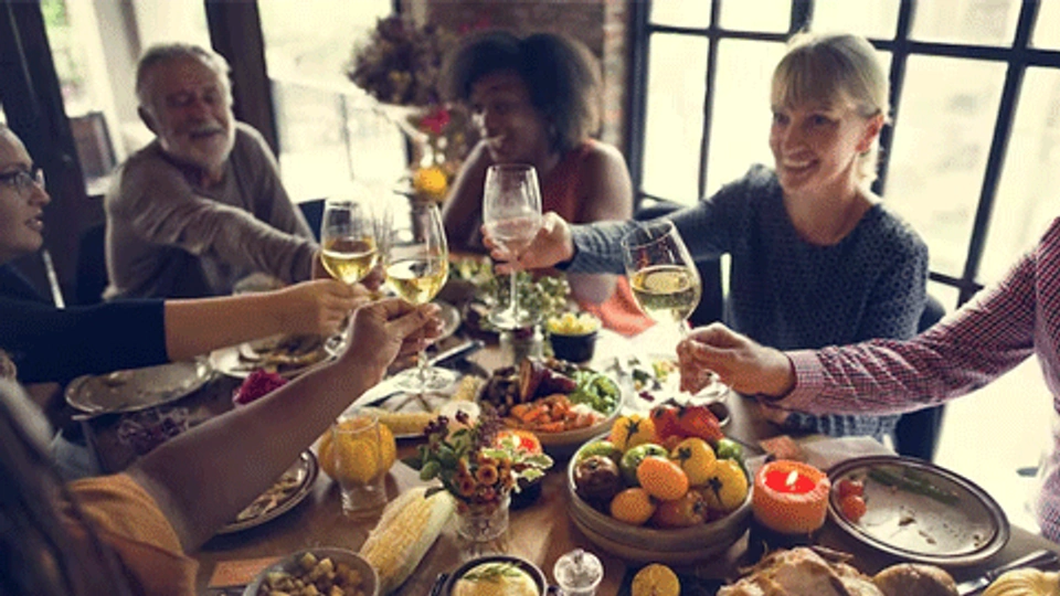 a group of people eating christmas dinner