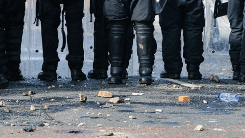 The lower bodies of a group of riot police