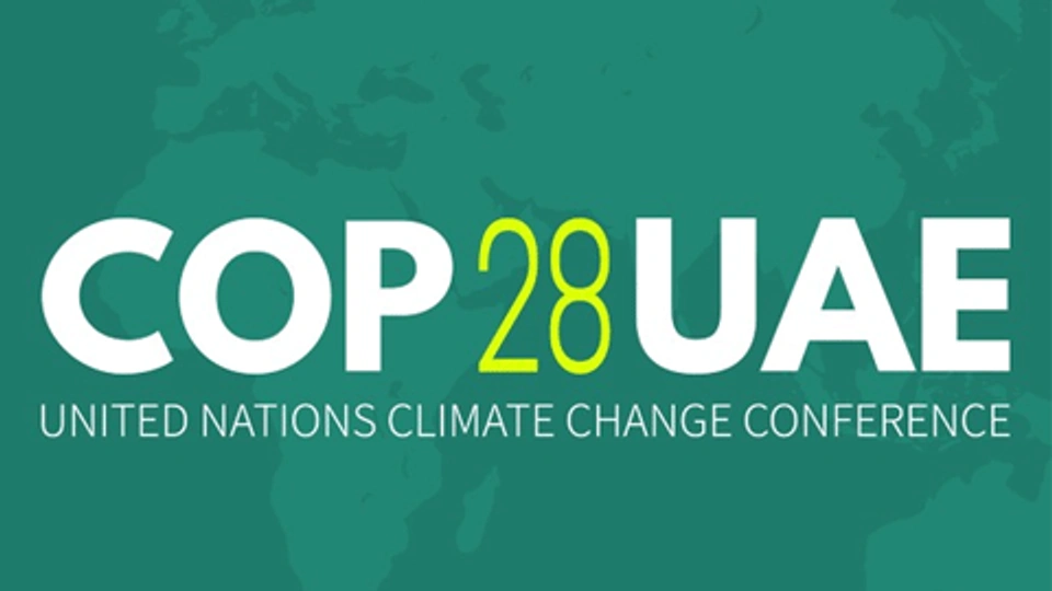 A green logo image with white words saying 'COP 28 UAE'