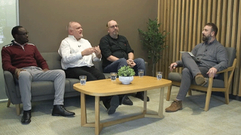 4 men seated having a discussion