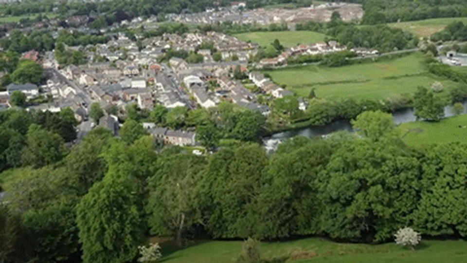 drone shot of a town and fields