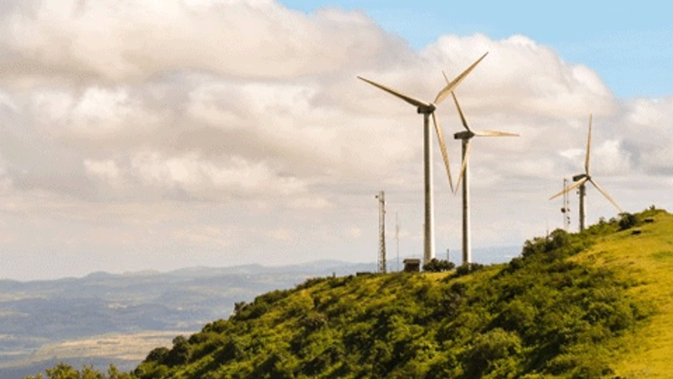 wind turbines on top of a hill