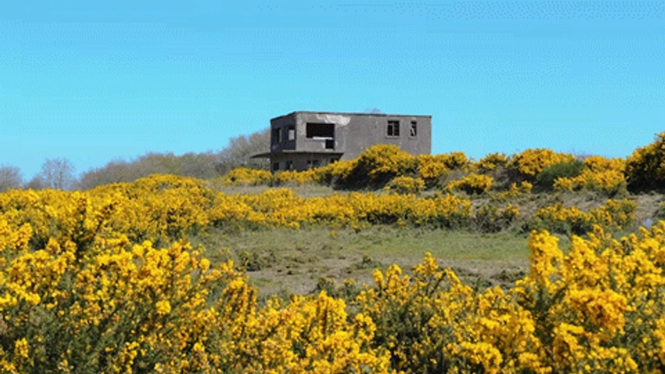 an abandoned control tower in a field