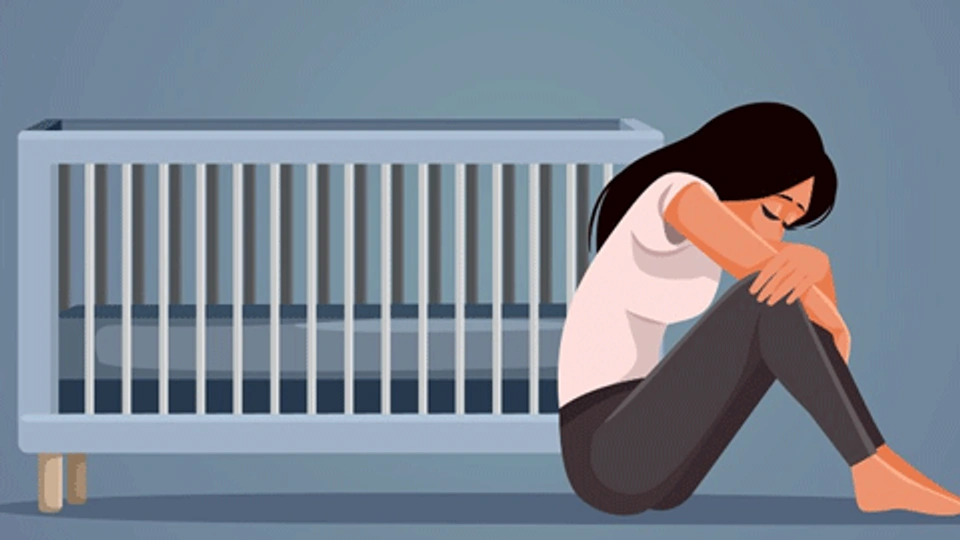 Graphic of a woman crying sat next to a crib
