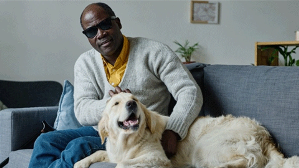 A blind man with his assistance dog