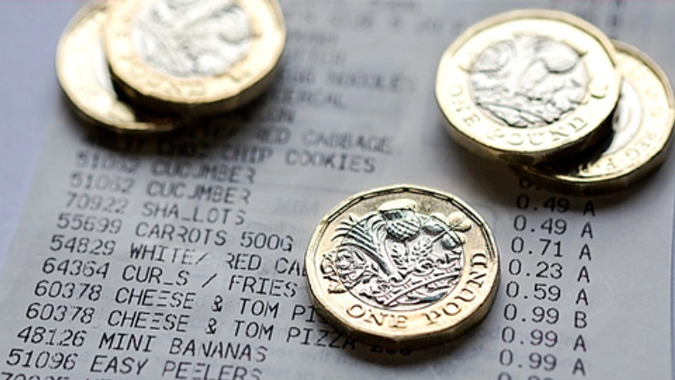 Pound coins on top of a receipt