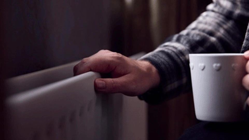 a hand holding on to a radiator