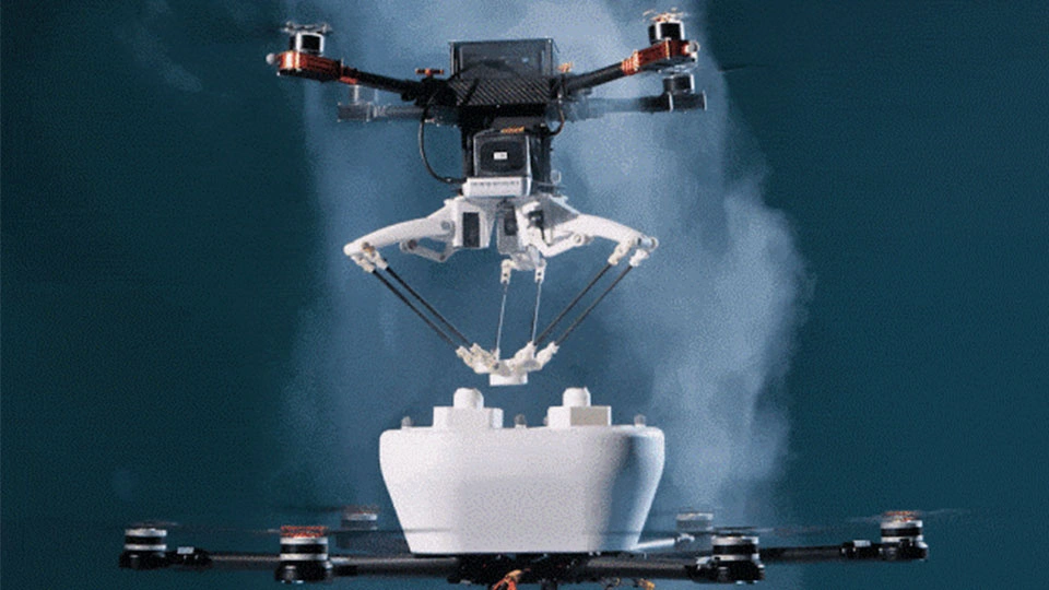 Two drones flying on top of each other with one taking tools from the other